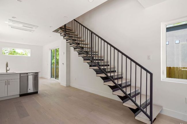 Stairs with wood finished floors and baseboards | Image 7