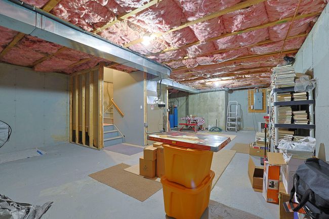 Unfinished below grade area featuring electric panel and stairs | Image 20
