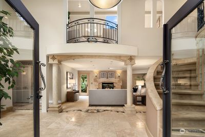 Soaring ceilings welcome you to the formal living room and elegant fireplace | Image 3