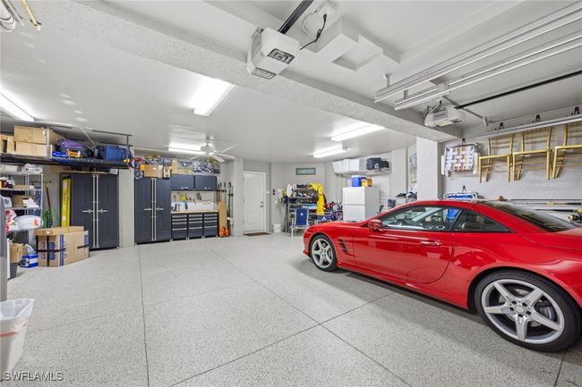 Spacious garage includes built in cabinets, epoxy floor, bike and kayak storage | Image 40