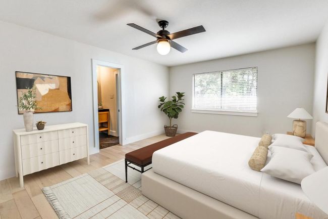 Bedroom featuring baseboards, a ceiling fan, ensuite bath, and light wood-style flooring | Image 6