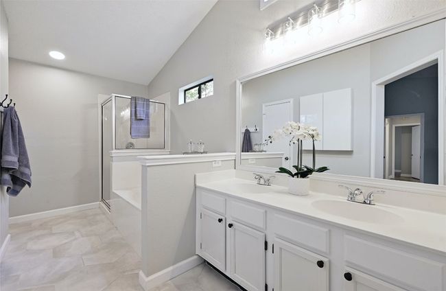 Upgraded octagon shaped tile flooring greets you in the spacious primary bathroom with dual vanities. | Image 17