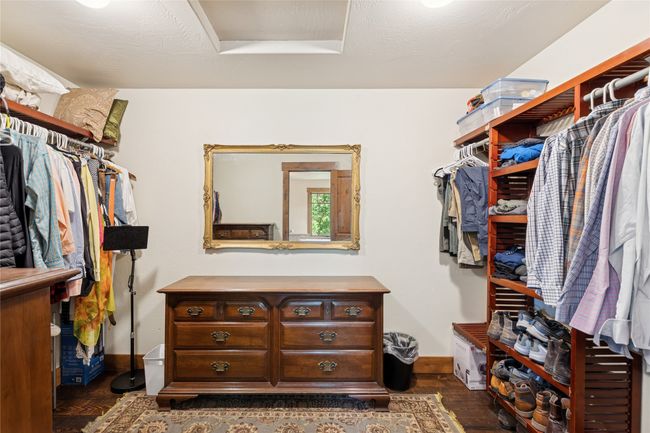 Spacious closet with attic access and dark wood finished floors | Image 36