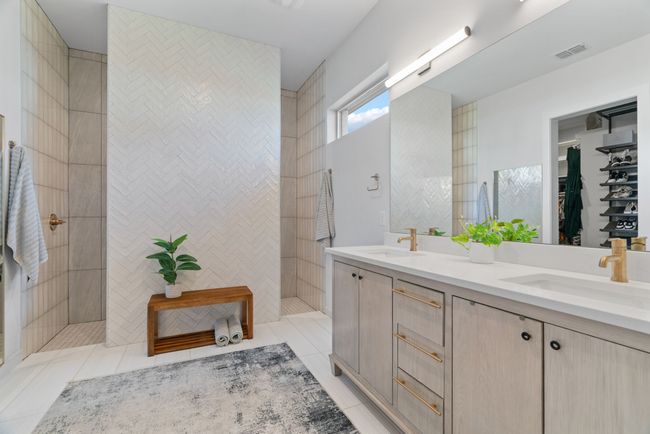 Bathroom with double vanity, tile patterned floors, and a walk in shower | Image 26