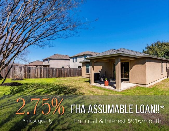 The spacious fenced-in backyard is your own private outdoor retreat with an expansive green lawn and a covered back porch. | Image 5