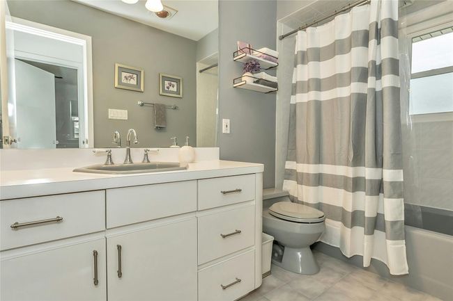Bathroom with tile patterned floors, toilet, shower / soak tub combination with and vanity | Image 14