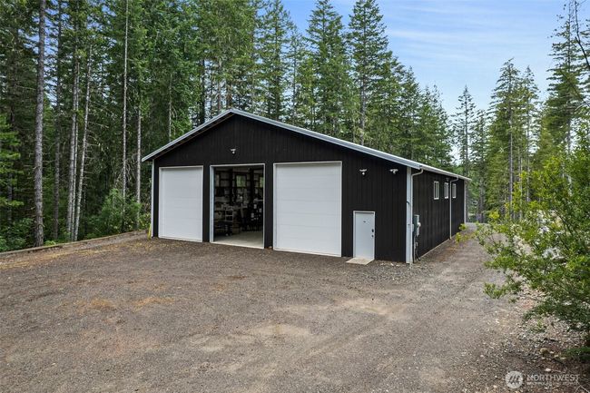 The driveway starts at the street, NE Tee Lake Road, and goes the full length of the property down to the home building site. The driveway is meandering from the main road to obscure the view of the property from the street. | Image 4