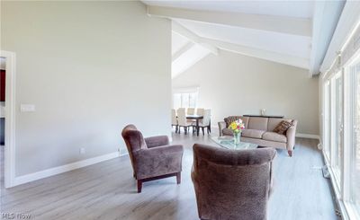 Sitting room featuring high vaulted ceiling, light hardwood / wood-style floors, and beam ceiling | Image 3