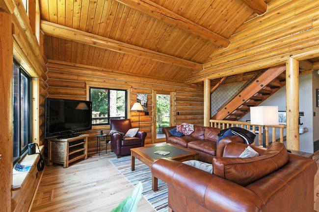 Living area featuring light wood finished floors, log walls, and wood ceiling | Image 16
