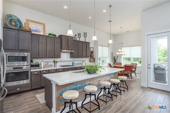 Kitchen toward dining. | Image 10
