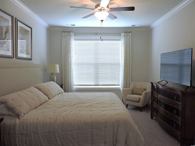 Bedroom featuring carpet flooring, crown molding, and a ceiling fan | Image 20