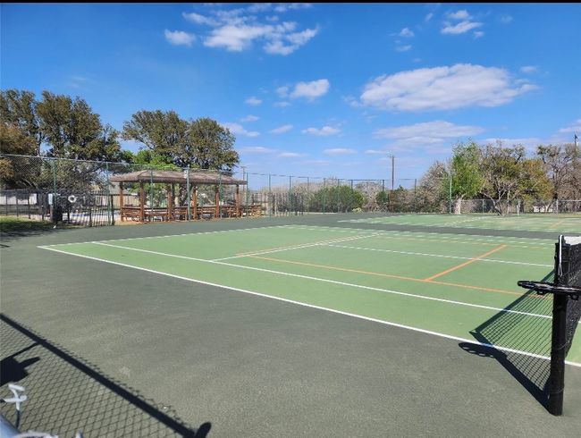 View of tennis court featuring fence and community basketball court | Image 10