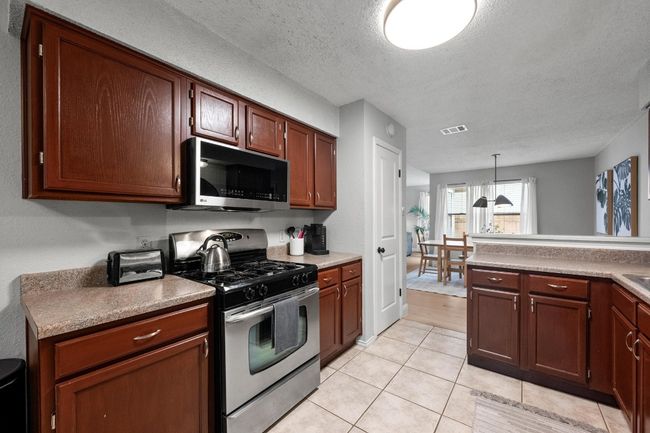 Kitchen with stainless steel appliances, and​​‌​​​​‌​​‌‌​‌‌​​​‌‌​​‌‌​‌​​​​​‌ pantry. | Image 11