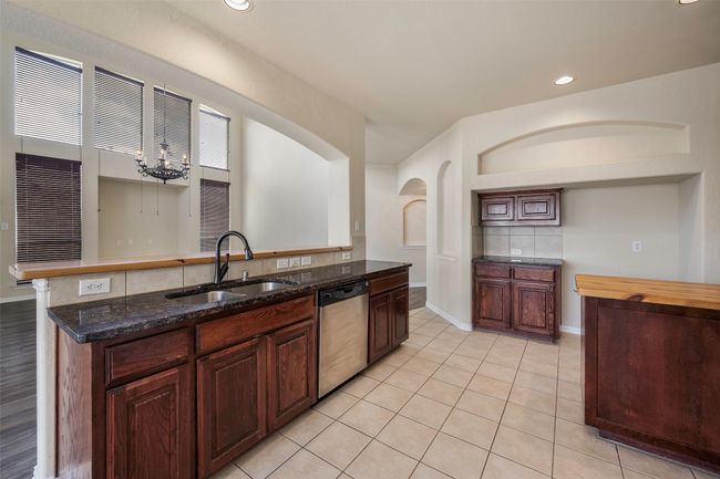 Kitchen features granite countertops as well as 2 custom handmade oak countertops | Image 21