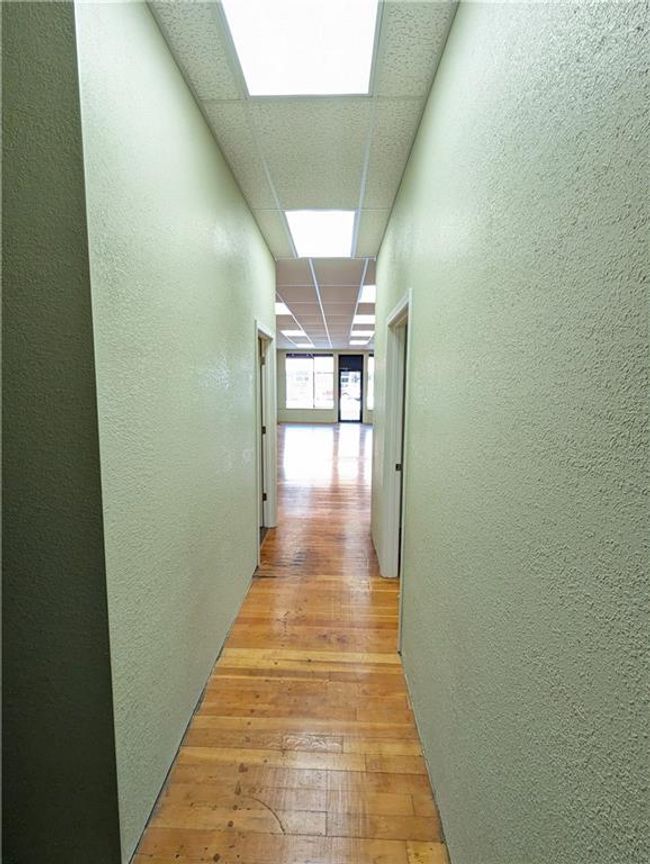 Hall featuring a paneled ceiling and light hardwood / wood-style floors | Image 16