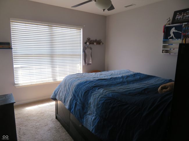 This bedroom has a large window overlooking the front yard.... | Image 35
