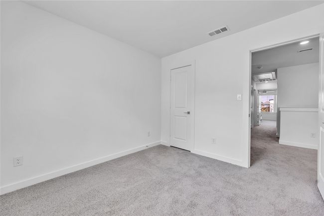 Unfurnished bedroom with carpet flooring, visible vents, and baseboards | Image 19
