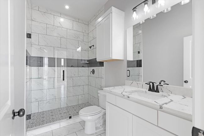 Full bath with marble finish flooring, vanity, a stall shower, and recessed lighting | Image 10
