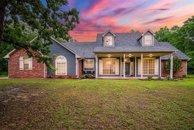 New england style home with a lawn | Image 1