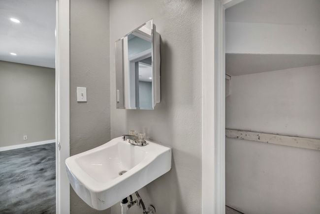 Bathroom with a sink, recessed lighting, and concrete flooring | Image 10
