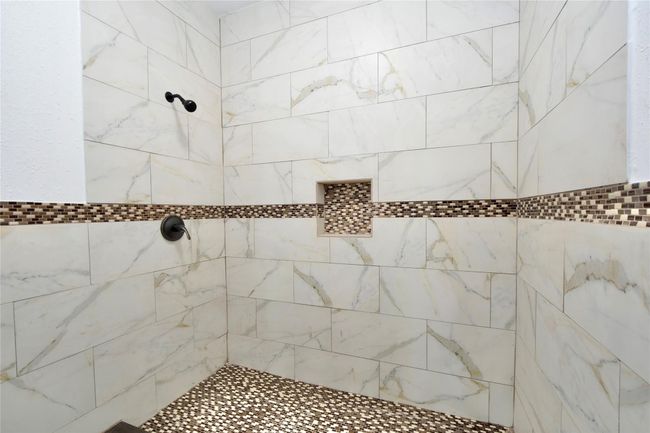 Bathroom featuring a tile shower | Image 10