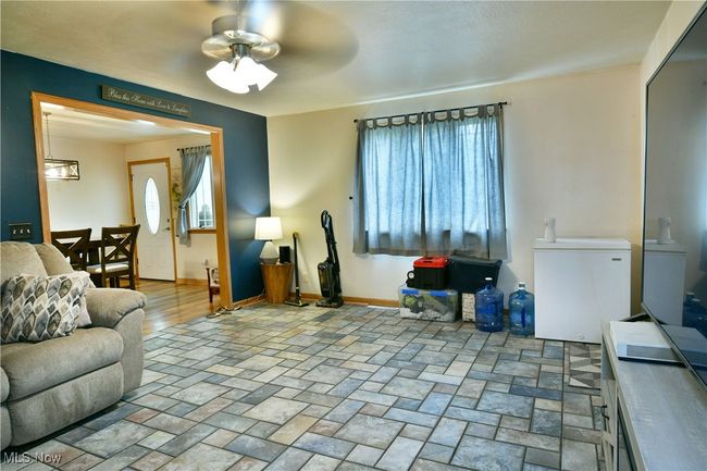 Living room featuring a ceiling fan and baseboards | Image 17