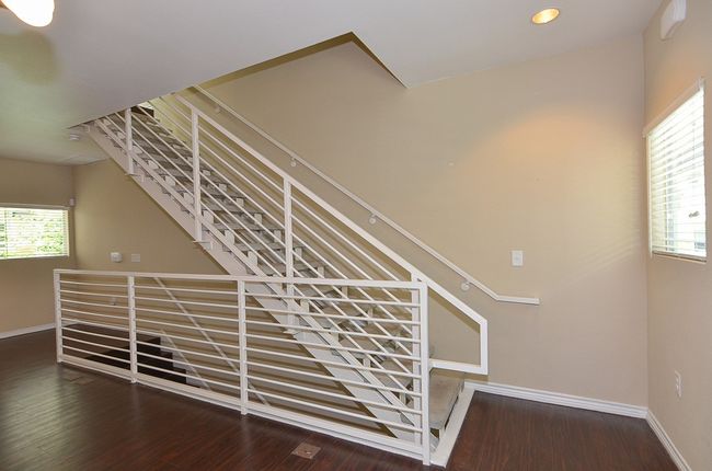 Stainrs in the living room - goes down to the ground/garage level and up to the bedroom level | Image 19