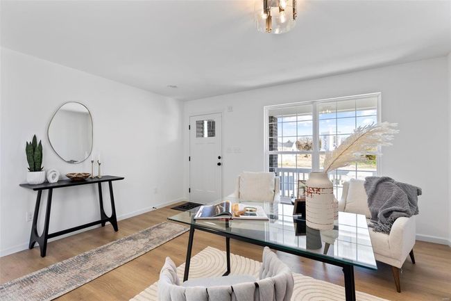 Living room with light hardwood / wood-style floors | Image 7