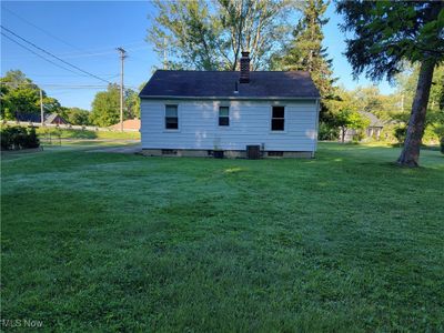 Rear view of property with a yard and central air condition unit | Image 3