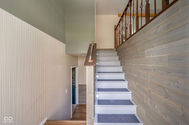 stairway featuring wooden walls | Image 29