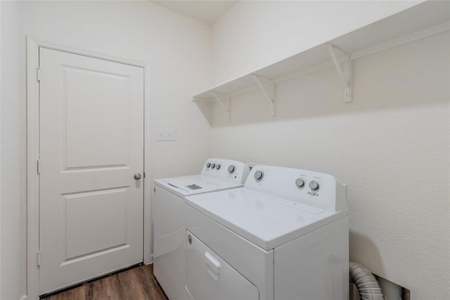Washroom featuring washer and dryer and dark wood-style flooring | Image 6