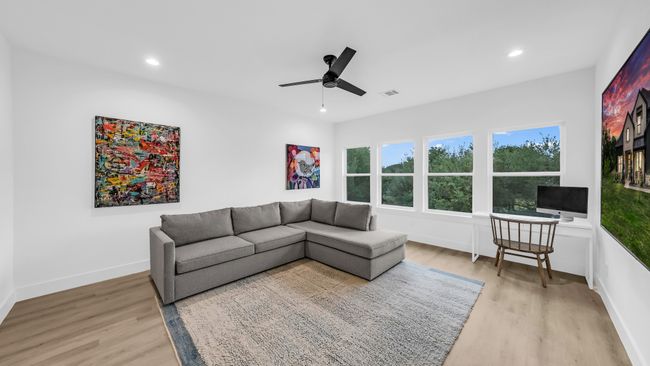 Living room featuring light wood finished floors, ceiling fan, baseboards, and recessed lighting | Image 22