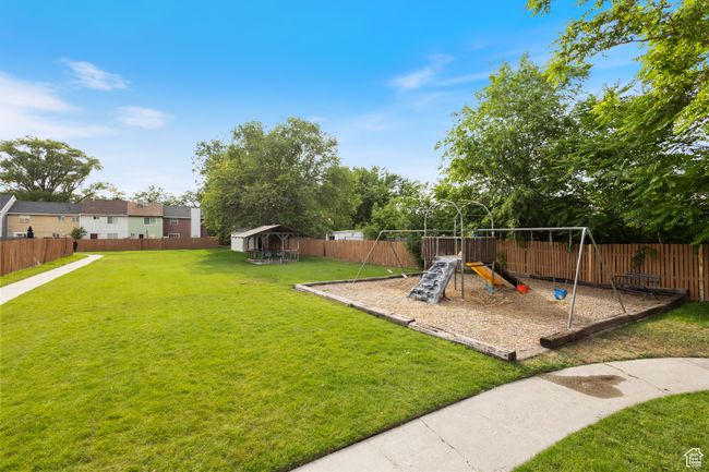 Fenced backyard with a playground | Image 22