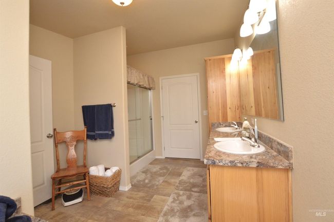 Bathroom with a stall shower and double vanity | Image 17