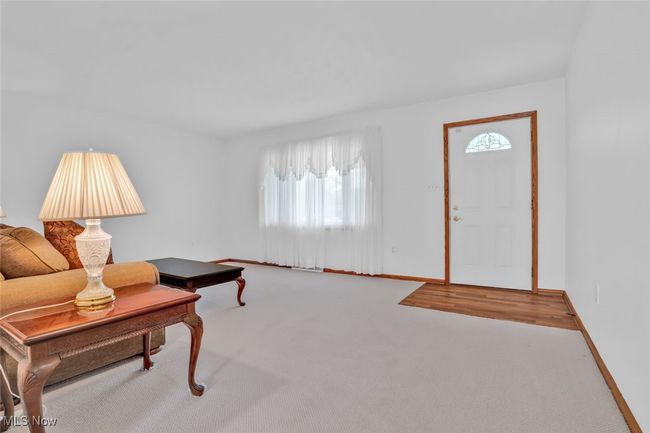Carpeted living room with plenty of natural light and baseboards | Image 8