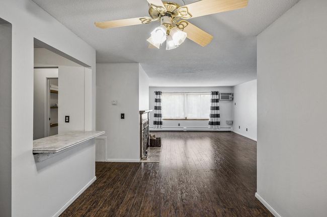 Abundant natural light pours in through the large window, creating a bright and airy feel. | Image 10