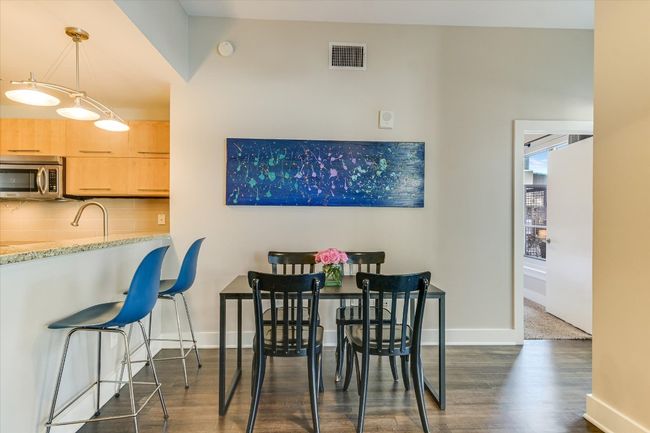 Dining area featuring visible vents, baseboards, and dark wood finished floors | Image 5