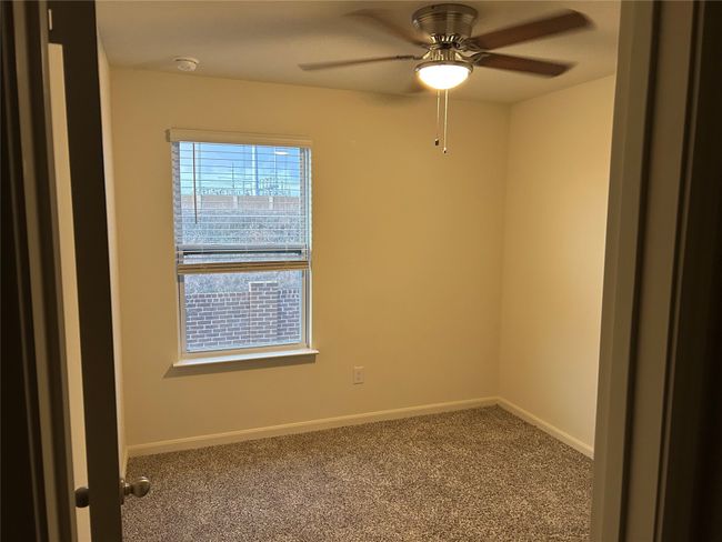 Empty room with carpet flooring, baseboards, and a ceiling fan | Image 15