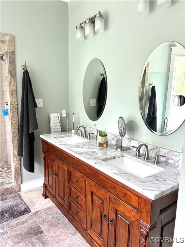 Bathroom with double vanity and tiled shower | Image 30