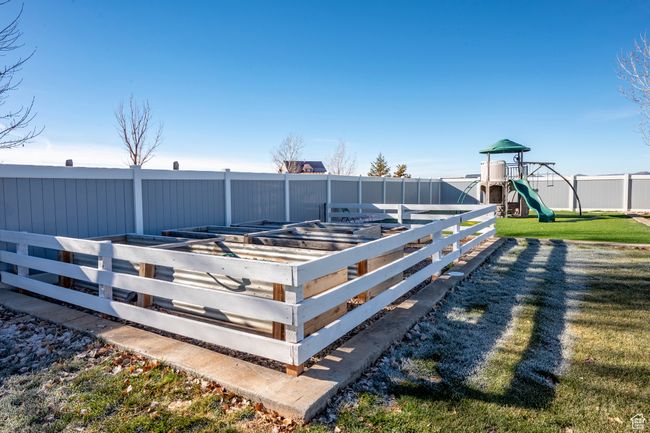Deck featuring a garden, fence, a playground, and a lawn | Image 57