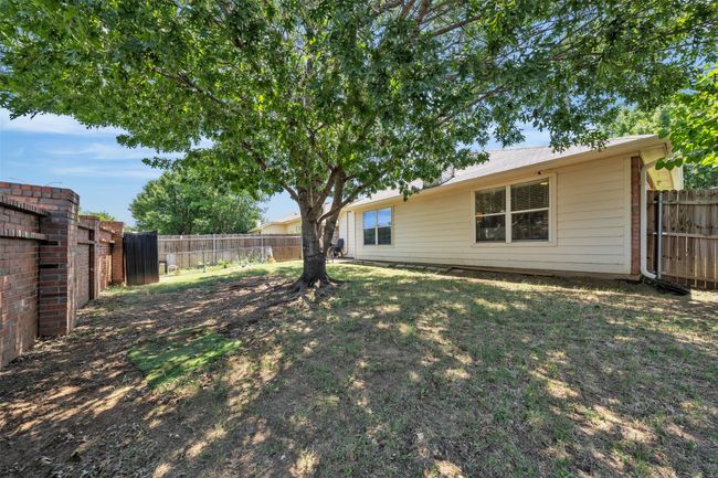 Shady backyard with brick and wood fencing | Image 19