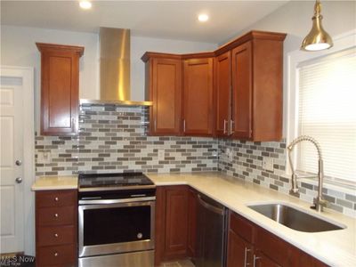 Customer Kitchens with beautiful tile work and stainless steel appliances | Image 3