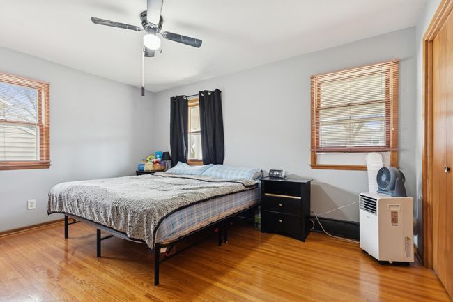 The primary bedroom has ample natural light and gorgeous hardwood floors! | Image 9