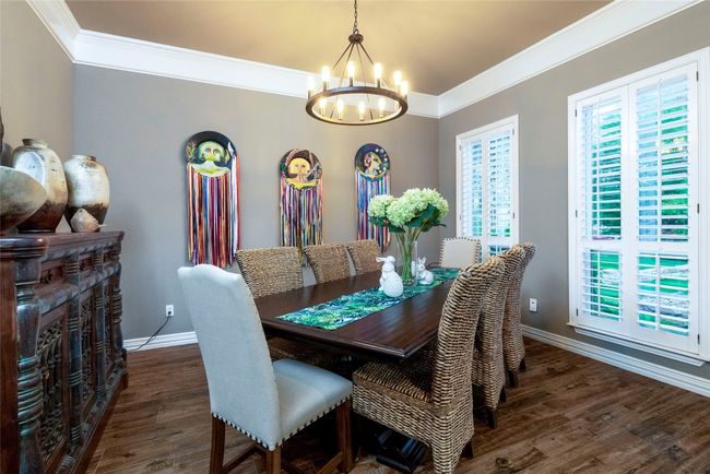 Dining room featuring designer lighting and wood-like flooring | Image 4