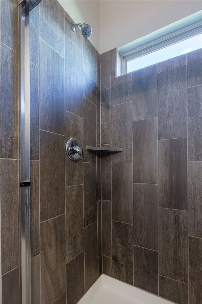 Bathroom featuring a tile shower | Image 30