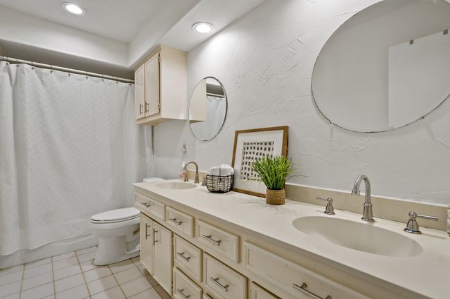 Full bathroom with toilet, recessed lighting, two sinks, and tile flooring | Image 18