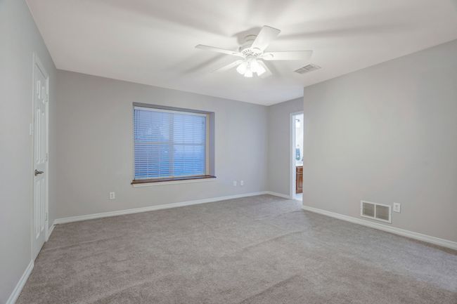 Fourth bedroom closet has walk-in attic space and charming window seat. | Image 36
