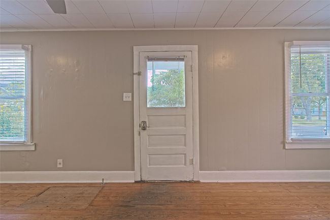 Entryway featuring crown molding, wood finished floors, and wooden walls | Image 8