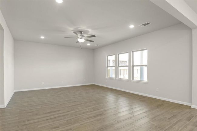 Spare room with wood finished floors, ceiling fan, baseboards, and recessed lighting | Image 5