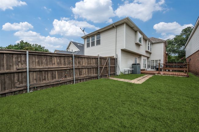 Rear view of house featuring a fenced backyard and a wooden deck | Image 18